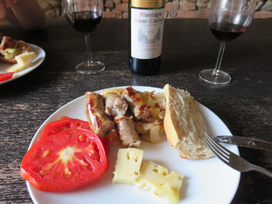 Our market food meal of Toulouse sausage, goats cheese, and tomatoes. What to see and do in Toulouse France #france #francetravel #toulouse