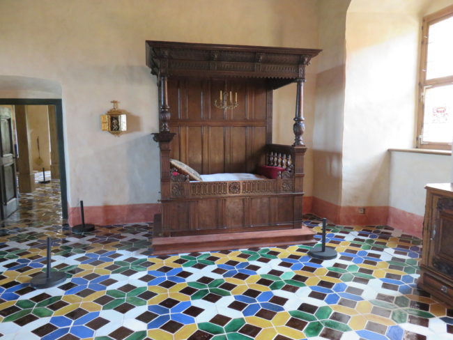 Bauska Castle bedroom with tiled floor. A guide to visiting Bauska Castle and Rundale Palace in #latvia