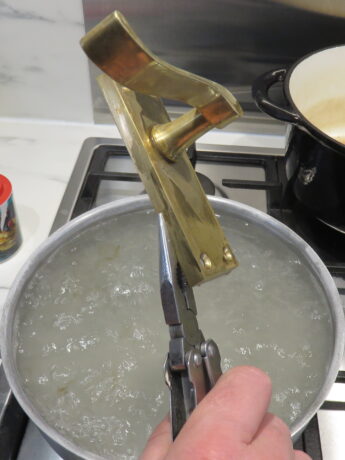 Use pliers or tongs to remove the handles from the water.